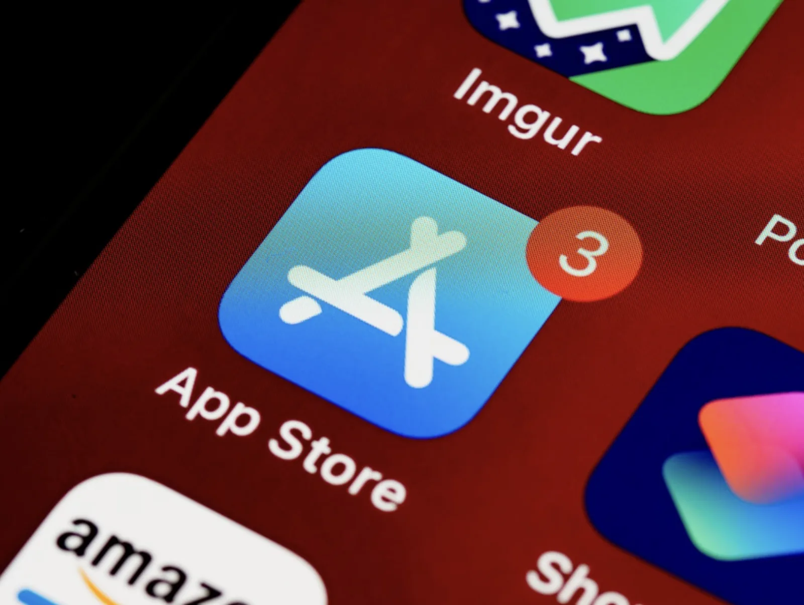Close-up of an iPhone home screen showing the App Store icon with a notification badge