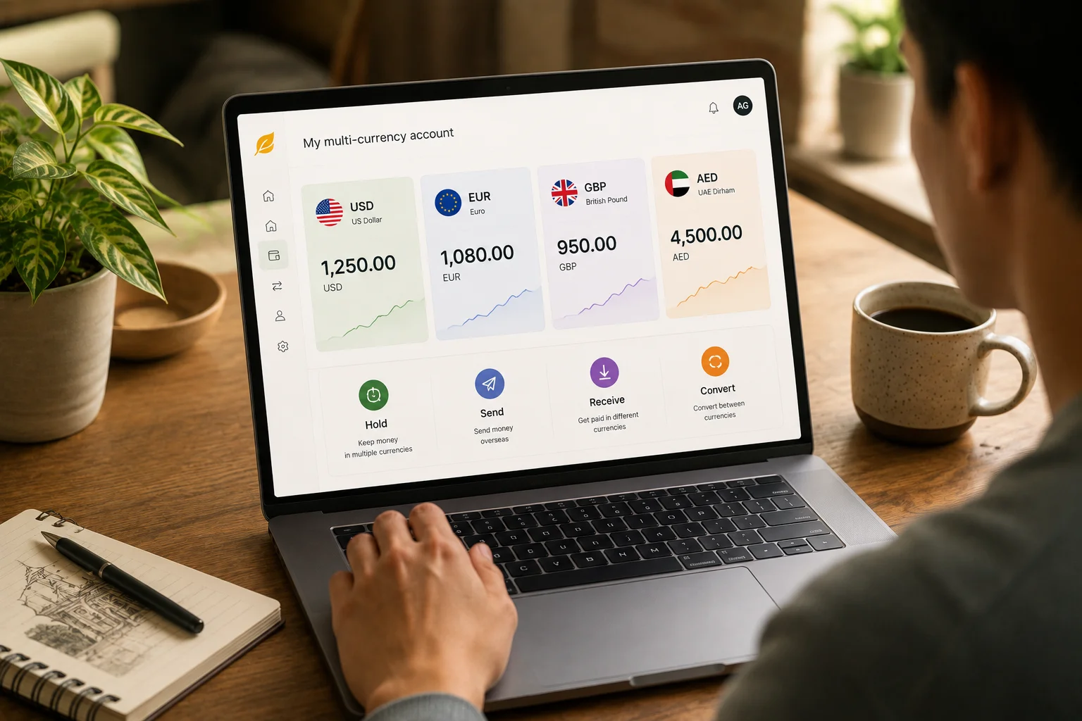 Person using a laptop showing a multi-currency account dashboard with USD, EUR, GBP, and AED balances